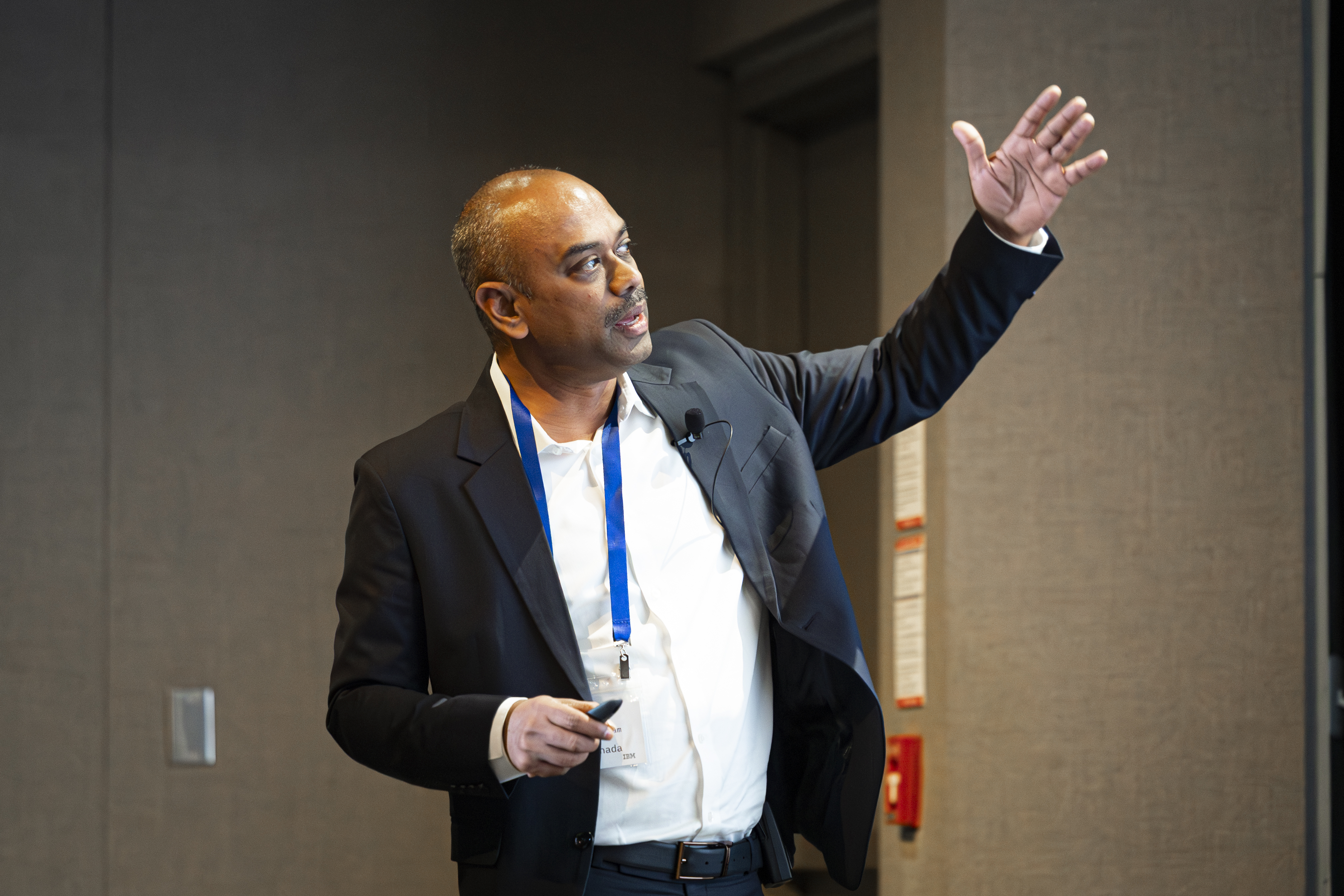 Image of Thiru Venkatachalam presenting on stage.